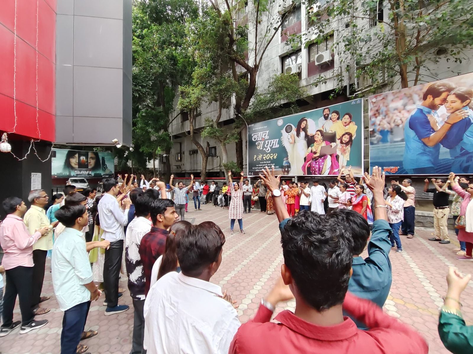A crowd with raised hands at a DigiAbility community gathering on a city street